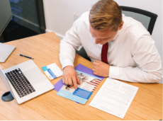 Fidelis employee reviewing brochures